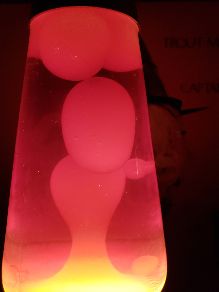 A lava lamp with a Captain
      Beefheart album behind it.